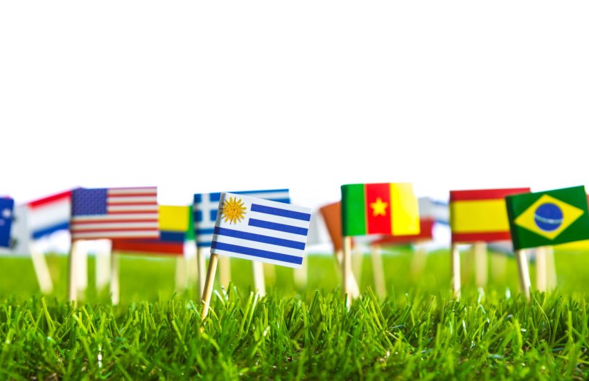 Paper cut of flags on grass for Soccer championship 2014